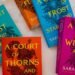 A Court of Thorns and Roses book set on a white bed