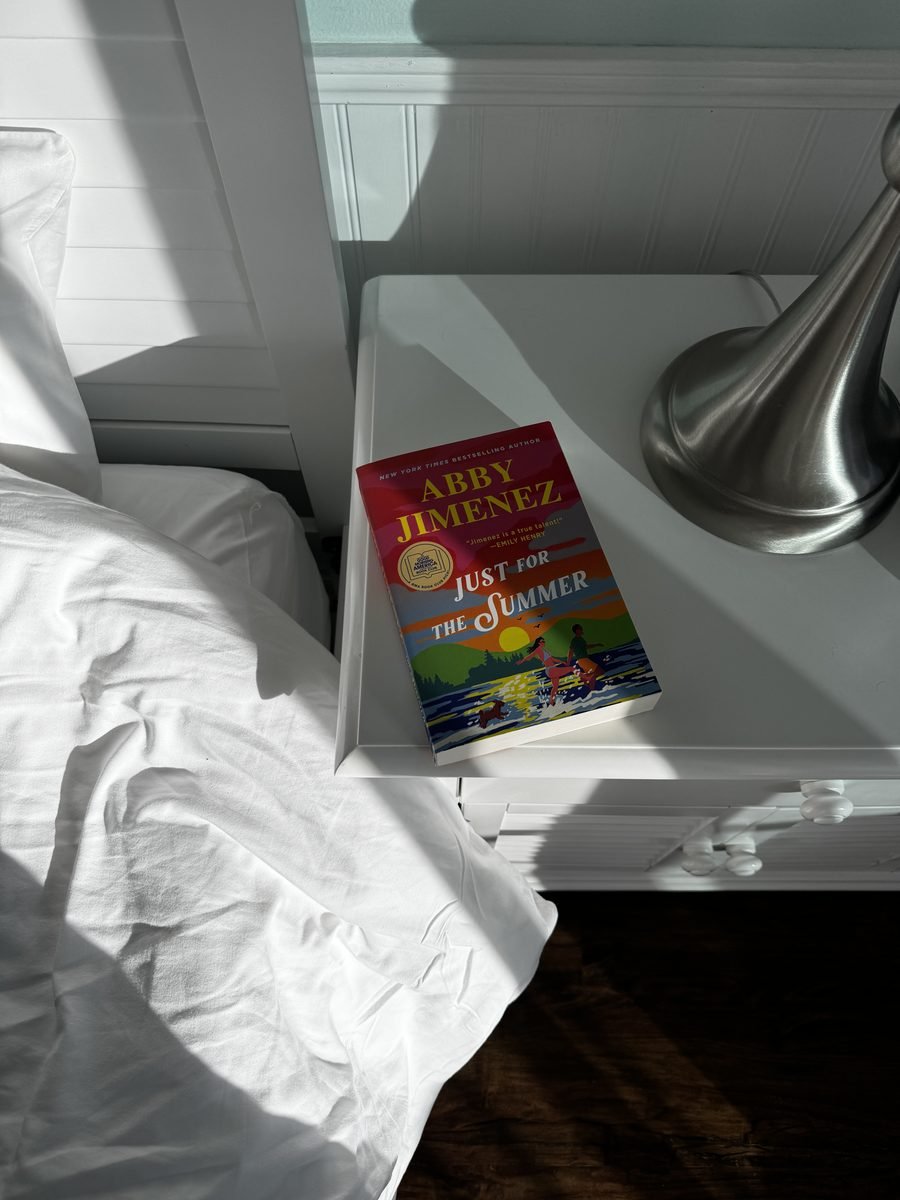 Just for the Summer by Abby Jimenez on a sunlit white nightstand
